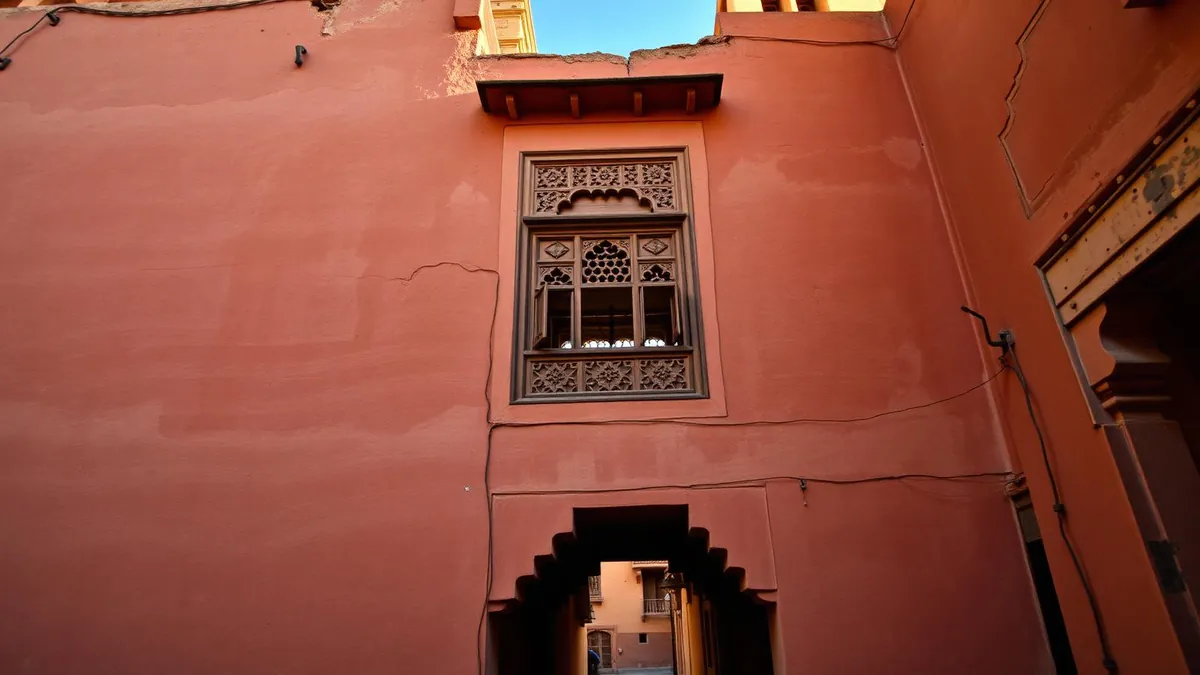 Warm red-sandstone haveli with a traditional jharokha window in Karauli, Rajasthan